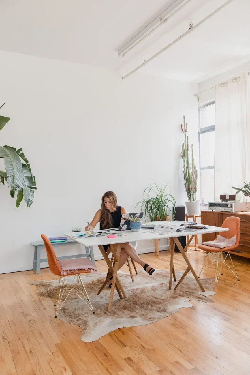 An airy loft studio with timber floors and plants in natural light