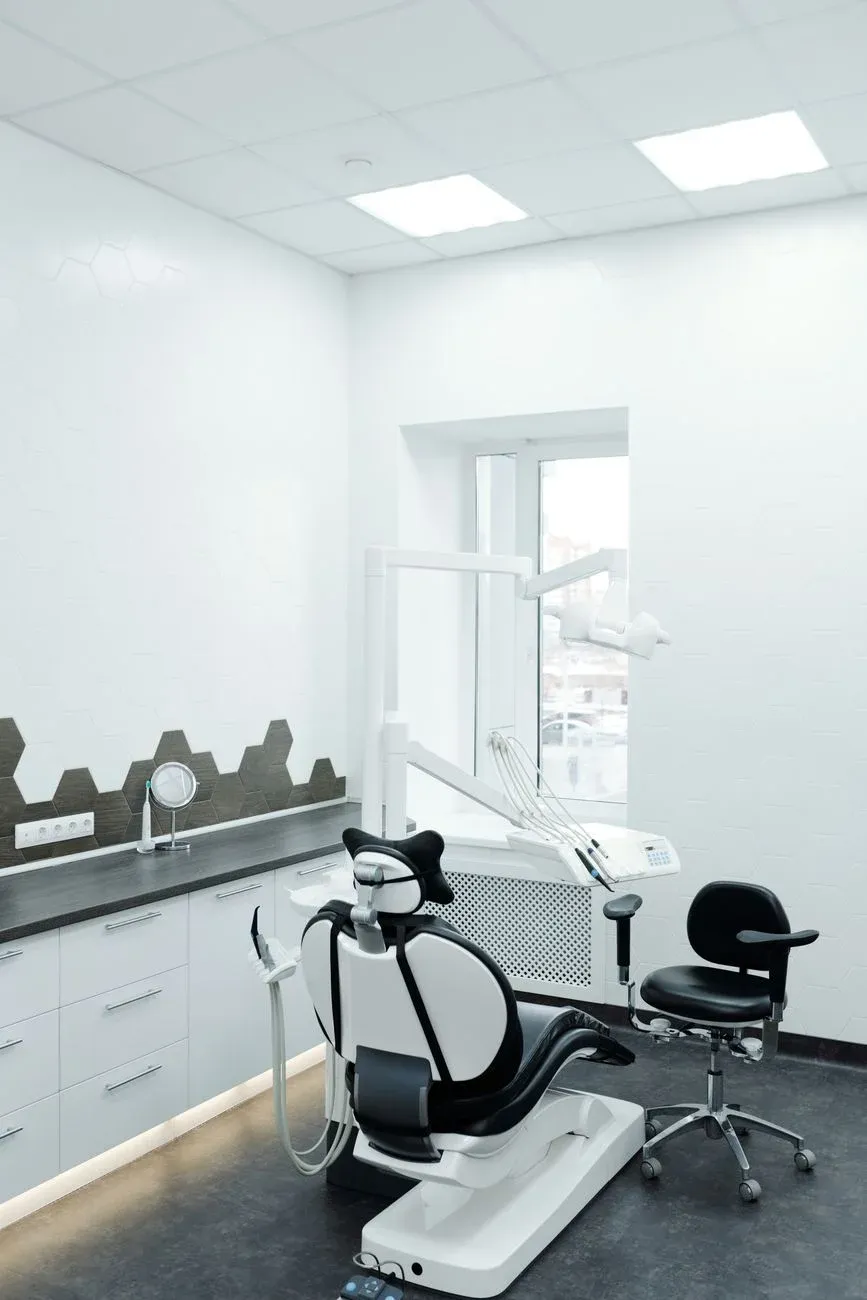 A bright modern dental treatment room with natural window light