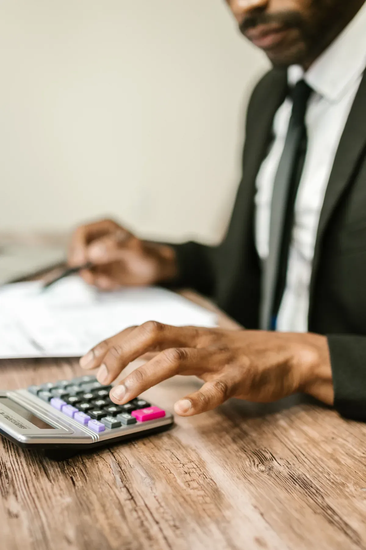 An Australian plan manager reviewing NDIS participant payments on a laptop at a bright office desk