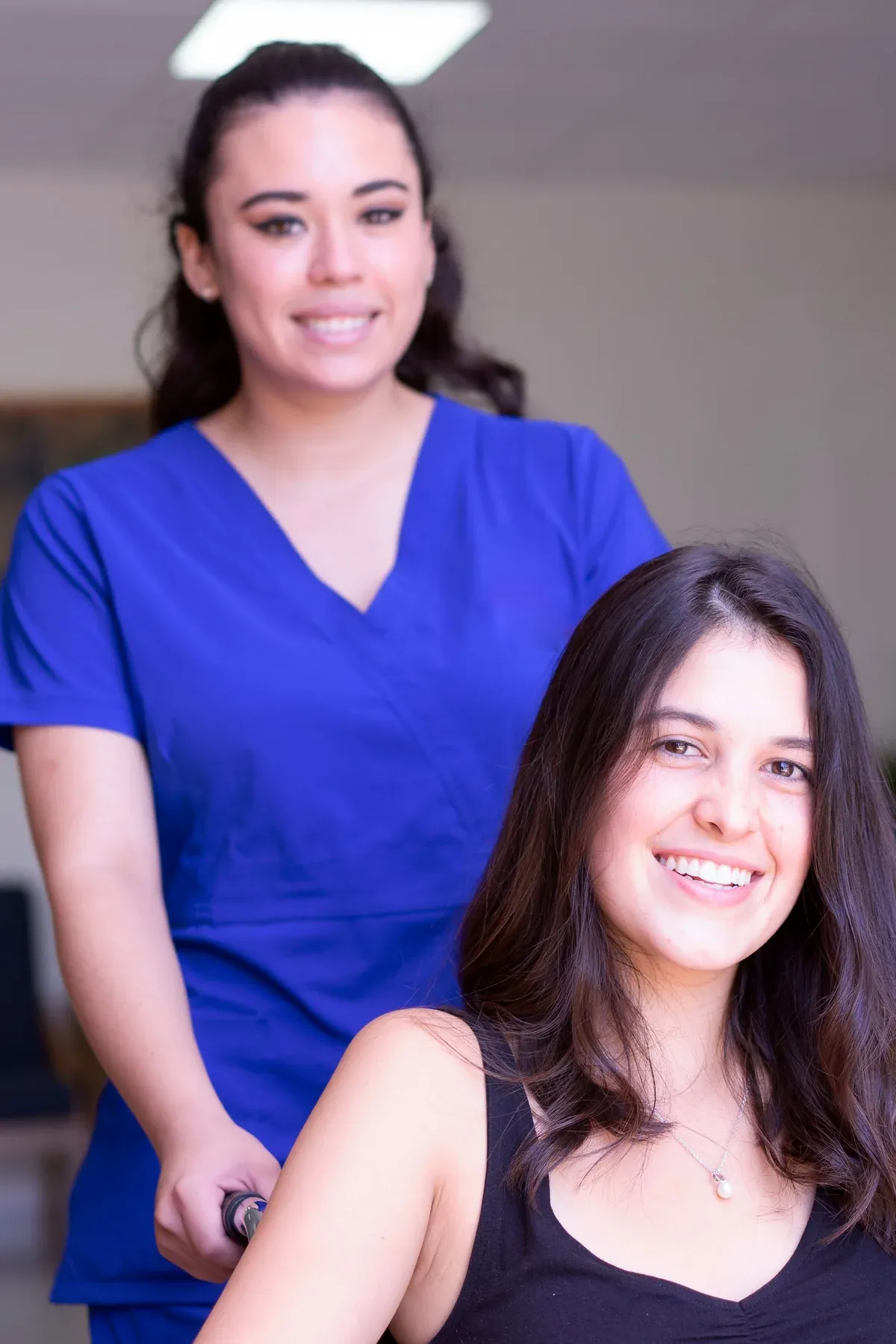 Australian disability support worker assisting a participant at a community centre activity, both smiling and engaged